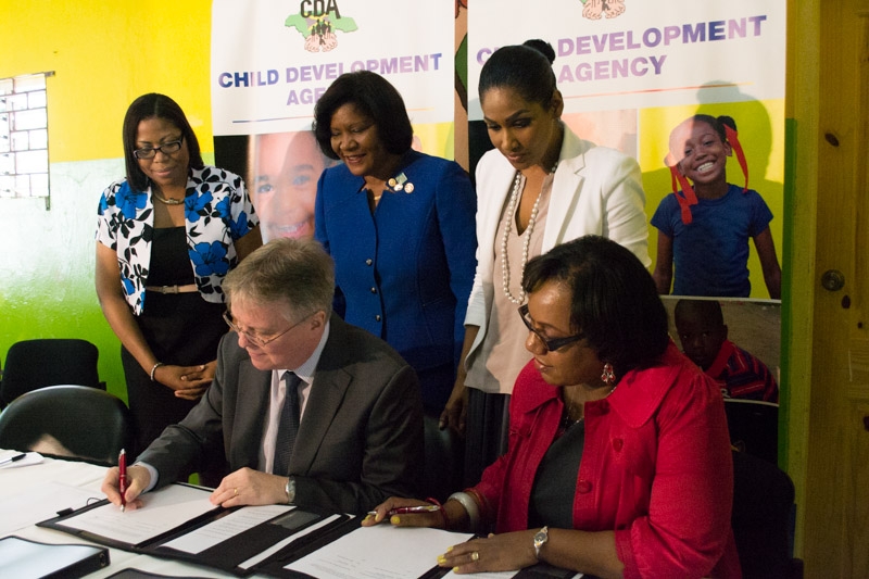 Minister of Youth and Culture the Hon. Lisa Hanna (right) observe as Acting CEO of the Child Development Agency (CDA) Rosalee Gage-Grey (right) and British High Commissioner His Excellency David Fitton sign a memorandum of understanding to guide the development of a transition home at the Homestead Place of Safety.   The British High Commission donated some $4 million in funding recently. The funds are also to support the equipping of the computer lab, home economics area and the recreational room.   Manager of the Homestead Child Care Facility Sophia Walters and President of the Rotary Club of St. Andrew Marie Powell look on.