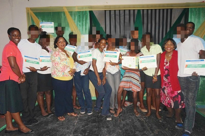 Members of the Child Development Agency Executive Management Team and Junior Achievement Jamaica share a moment with the participants of the Junior Achievement Jamaica programme, at an appreciation ceremony held recently at the Maxfield Park Children’s Home in Kingston. Approximately 13 wards of the State were recognized for their participation in a three-week career and success training course which ended on August 5. The programme was a joint venture between CDA and Junior Achievement Jamaica. Front row: Chief Executive Officer of the CDA, Rosalee Gage-Grey (third left); Facilitator at Junior Achievement Jamaica, Zann Locke (centre); CDA’s Director of Children and Family Programmes, Audrey Budhi (1st right) and Director for Policy, Planning and Evaluation, Newton Douglas (right in the back row).