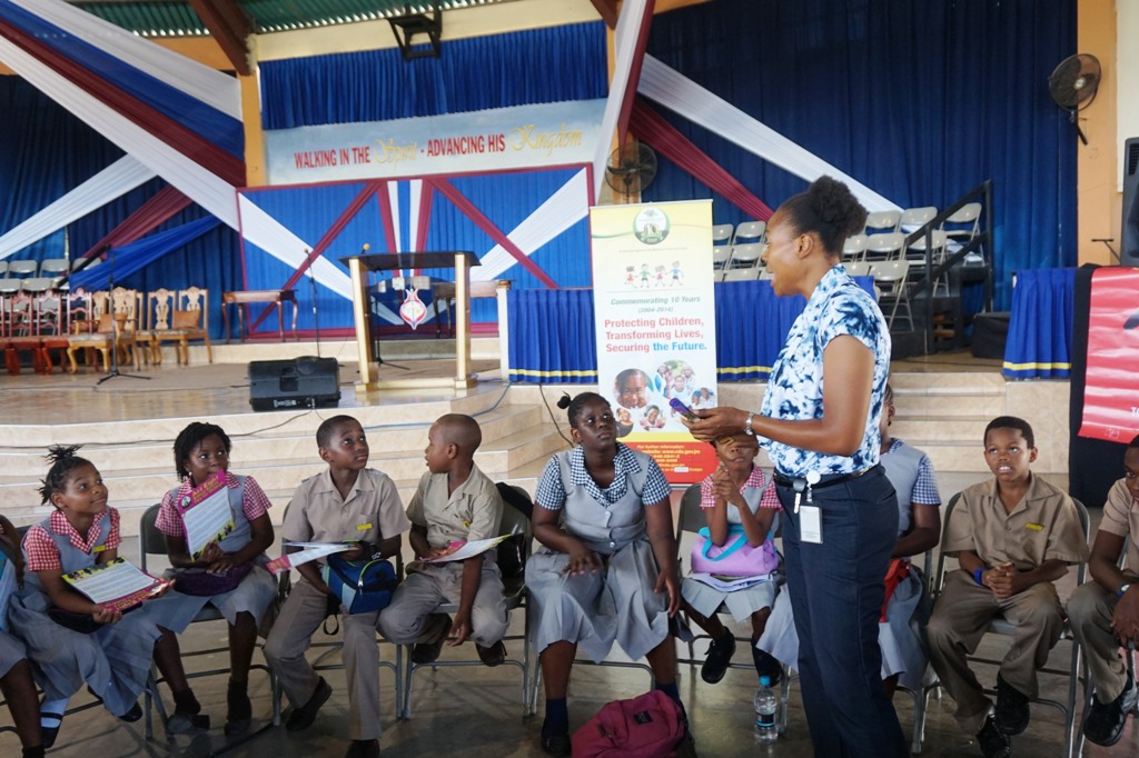 Child Development Agency Social Worker Caleisha Hylton holds a child abuse prevention session at the symposium recently put on by the St. Catherine Child Protection Committee in association with the Child Development Agency, at the Church of God of Prophecy, Old Harbour.  Over 200 children from across the parish participated.